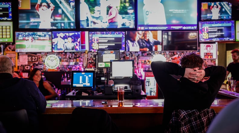 Baseball was on the televisions at Fricker's on Springboro Pike near the Dayton Mall Thursday evening April 7, 0222. Exactly when Ohioans will have the opportunity to make a legal sports bet in the state remains unknown, but an expert says it’s possible it will be just a few months away. JIM NOELKER/STAFF