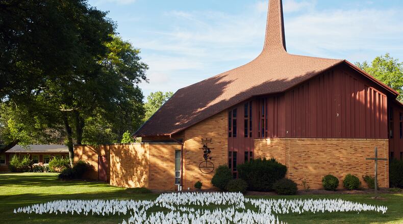 FILE -- A memorial of flags honoring Ohioans who have died from COVID-19 at the Church of the Redeemer United Church of Christ in Westlake, Ohio, on Sept. 11, 2020. The death toll in the United States from the coronavirus pandemic passed 200,000 on Tuesday, Sept. 22, 2020 as the first day of fall brings questions about what may be ahead. (Da'Shaunaue Marisa/The New York Times)