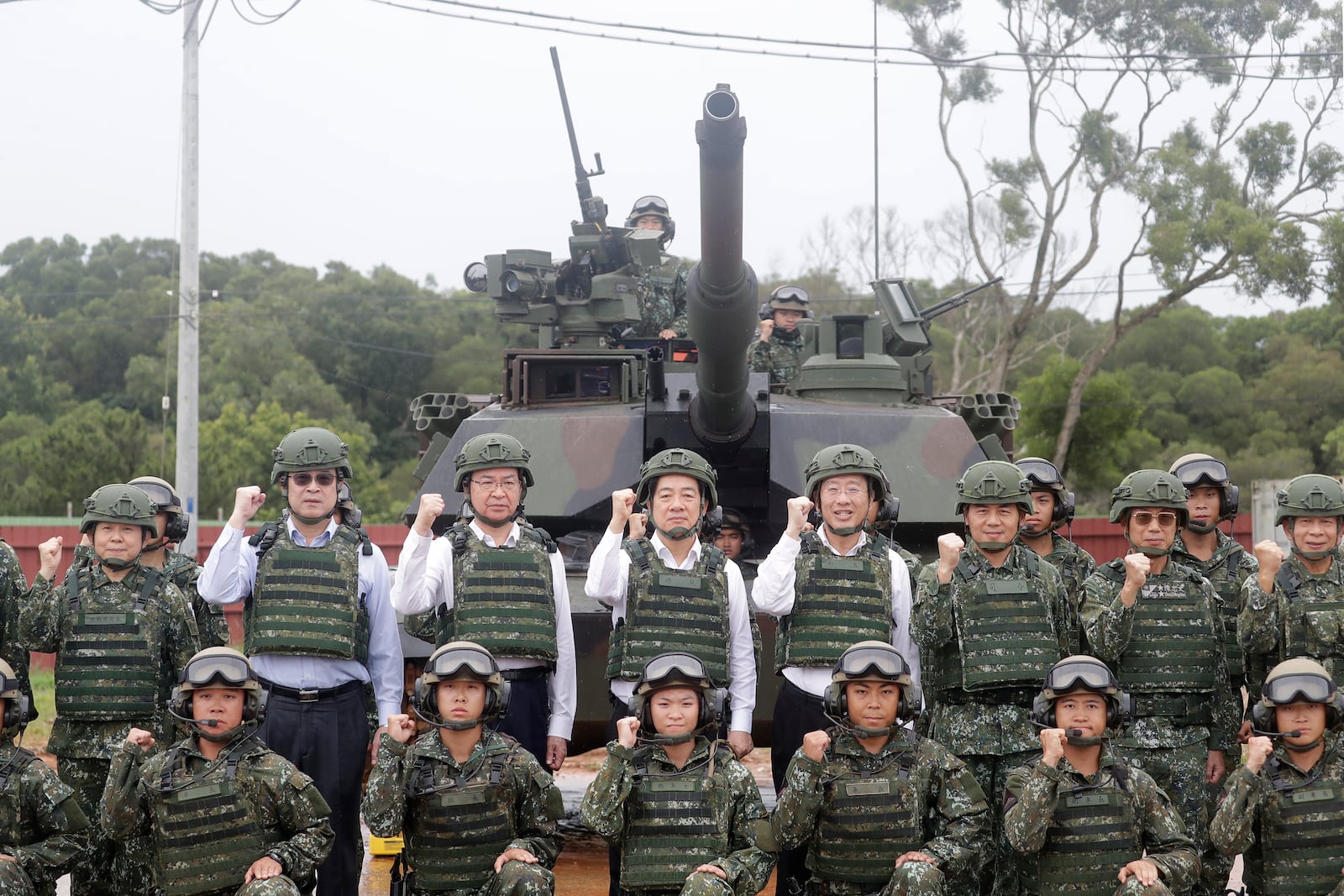 Taiwan President Lai Ching-te, center left in second row, poses with soldiers during a live-fire shooting training in Hsinchu County, Taiwan, Thursday, July 10, 2025. (AP Photo/Chiang Ying-ying)
