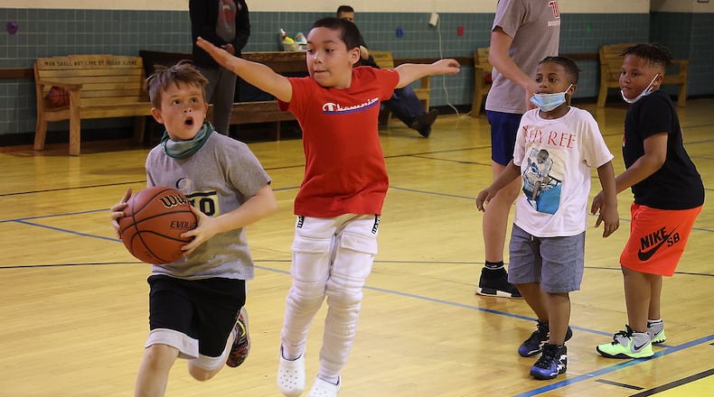 The kids in the Brake the Cycle youth group practice Thursday evening at the Gary Lutz Gopher Dome in preparation for their game against law enforcement next week. BILL LACKEY/STAFF