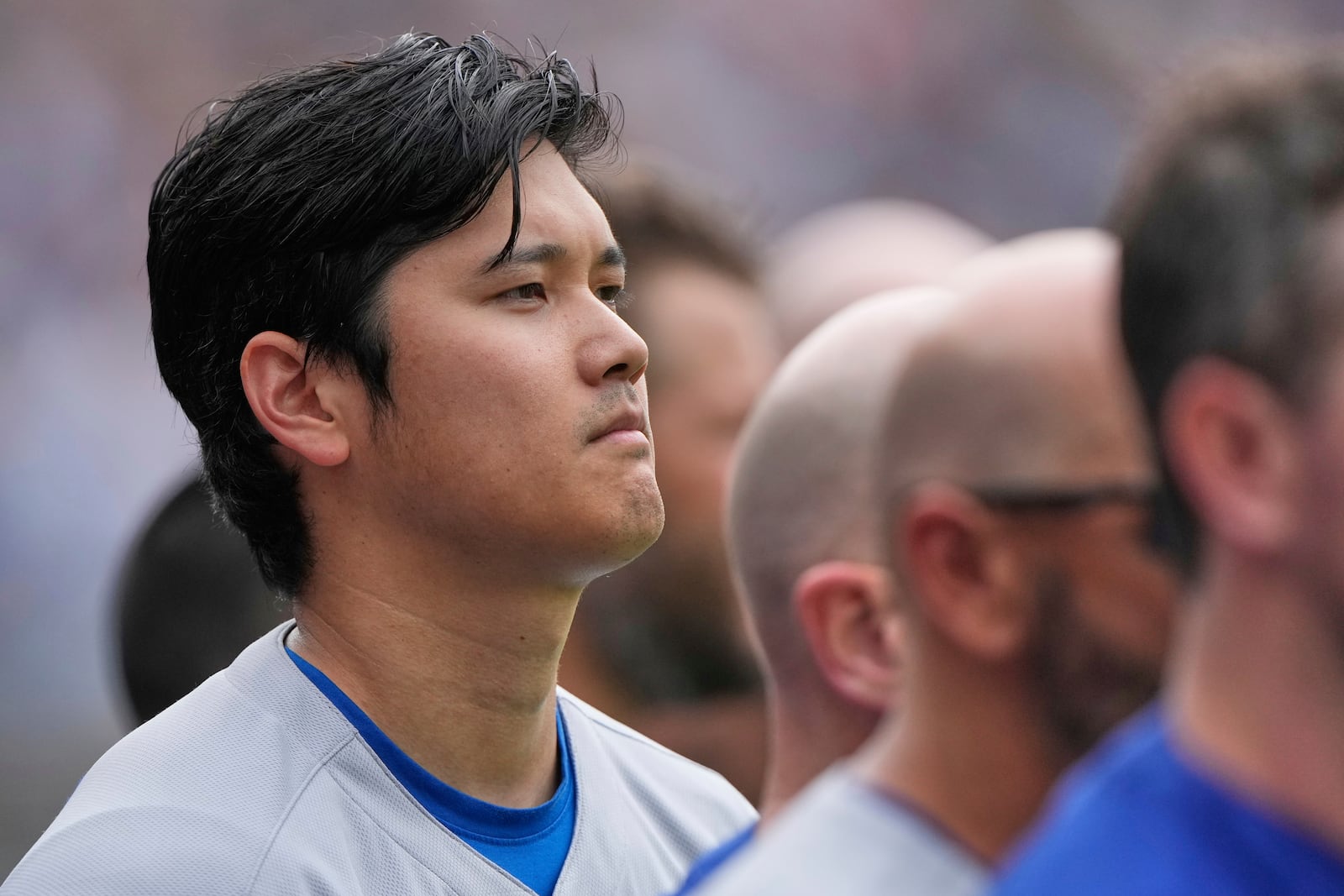 Los Angeles Dodgers' Shohei Ohtani listens to the national anthem before a baseball game against the Kansas City Royals, Sunday, June 29, 2025, in Kansas City, Mo. (AP Photo/Charlie Riedel)
