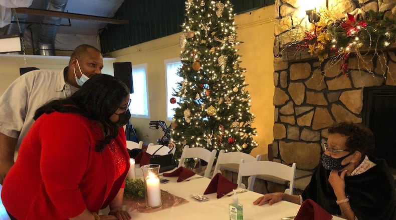 Alice Marshall talks with former neighbors Nina and Max St. Luce during Marshall's 100th birthday celebration on Dec. 4 at the Simon Kenton Inn. Marshall, a retired Springfield City Schools teacher, has stayed active in the community and still going strong. More than 100 attended the event. Photo by Brett Turner