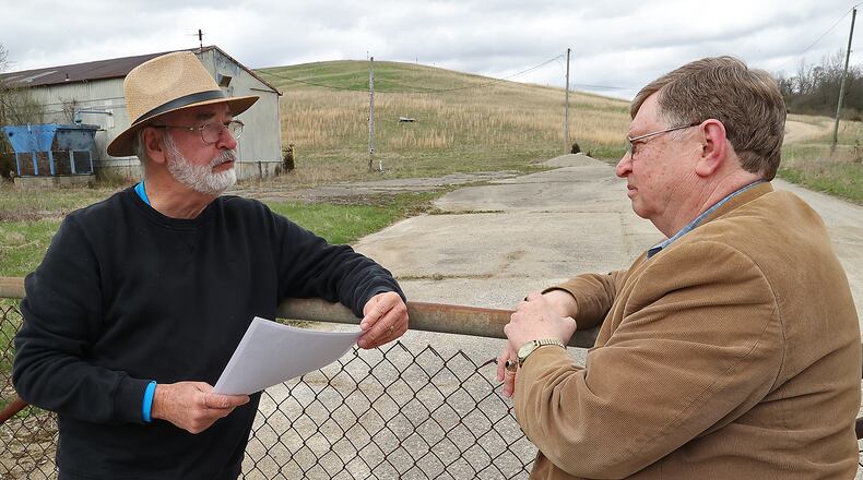 Springfield City Commissioner Dave Estrop talks with Larry Ricketts, from the group People for Safe Water, at the entrance to the Tremont City Barrel Fill Tuesday, April 12, 2022. BILL LACKEY/STAFF