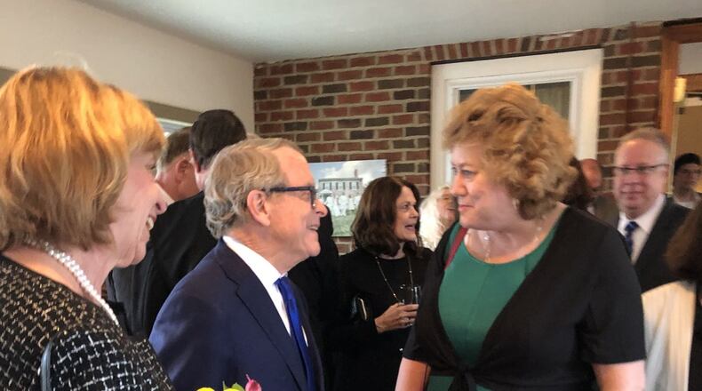 Ohio Gov. Mike DeWine meets Melanie Seitz, right, at a social hour prior to the Clark County Republican Party 2019 Lincoln Day Dinner on Friday, April 5. At left is Ohio First Lady Fran DeWine. Photo by Brett Turner