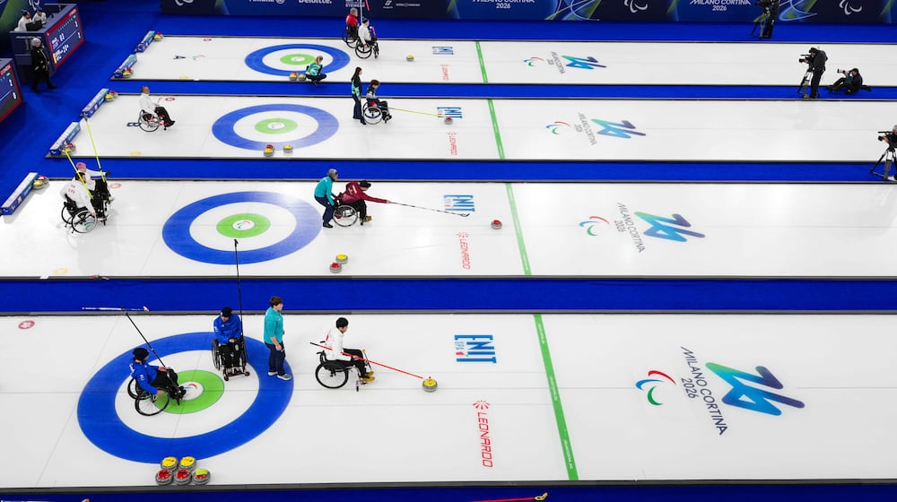 Athletes compete during wheelchair curling mixed doubles matches at the 2026 Winter Paralympics, in Cortina d'Ampezzo, Italy, Thursday, March 5, 2026. (AP Photo/Evgeniy Maloletka)