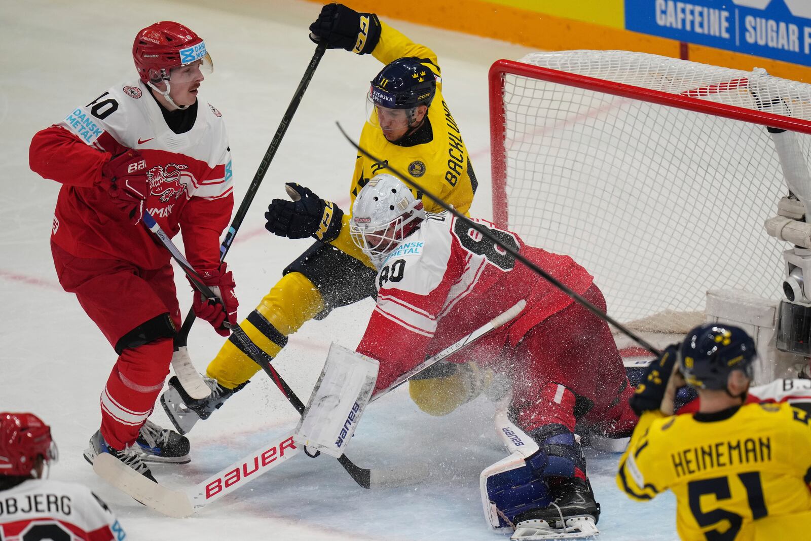 Sweden's Mikael Backlund in action in front of Denmark's goalkeeper Frederik Dichow during the bronze medal match between Denmark and Sweden at the ice hockey world championships in Stockholm, Sweden, Sunday, May 25, 2025. (AP Photo/Petr David Josek)