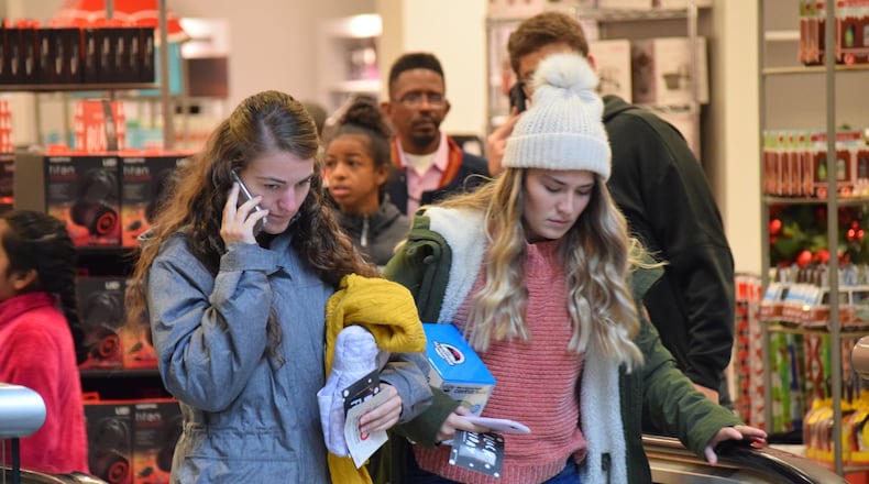 Jill Kelly, 21 of Germantown, shops with her 18-year-old sister Jessica at JCPenney when it opened at 2 p.m. Thursday. The two prefer to shop in store over online, but will look for a good deal today. STAFF PHOTO / HOLLY SHIVELY