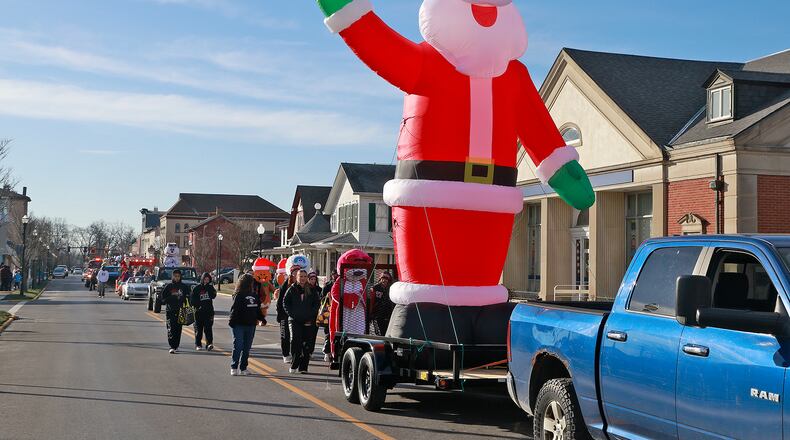 The air was chilly but the holiday spirit was warm for the City of New Carlisle's annual Christmas Parade Saturday, Dec. 7, 2024. The parade traveled along Main Street with Santa, the Tecumseh High School Band and inflatable holiday characters before ending at the New Carlisle Fire Station on Church Street. At the fire station, the band played while children got to meet Santa and get juice and cookies. BILL LACKEY/STAFF