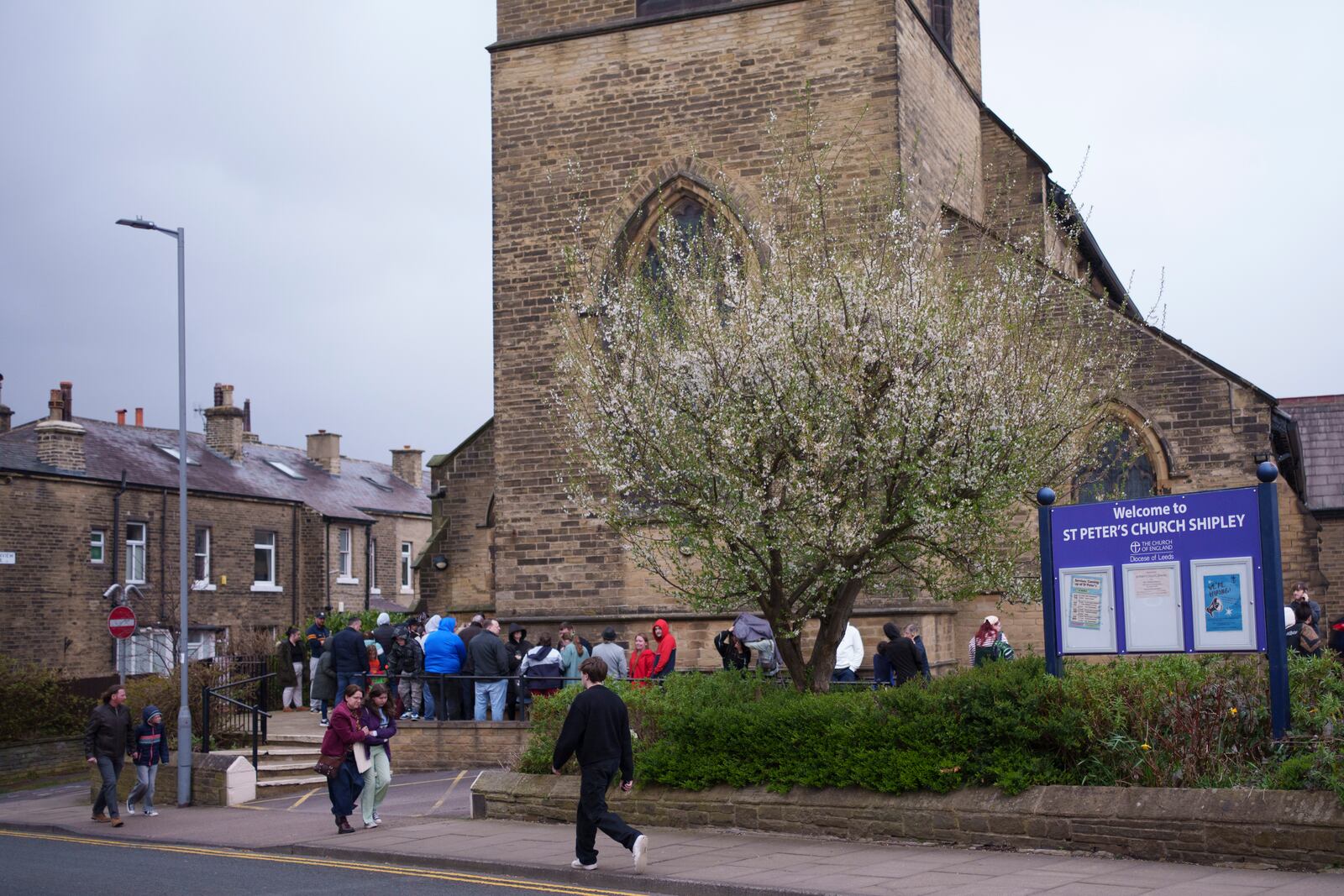 Spectators queue outside St Peter's Church in Shipley before one of the Kingdom Wrestling's monthly wrestling shows, Saturday, March 29, 2025. (AP Photo/Jon Super)