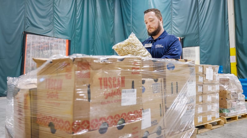Executive director Alex Jackson determines what food is in certain boxes at Second Harvest Food Bank on Thursday, Nov. 13, 2025, in Springfield. JOSEPH COOKE/STAFF