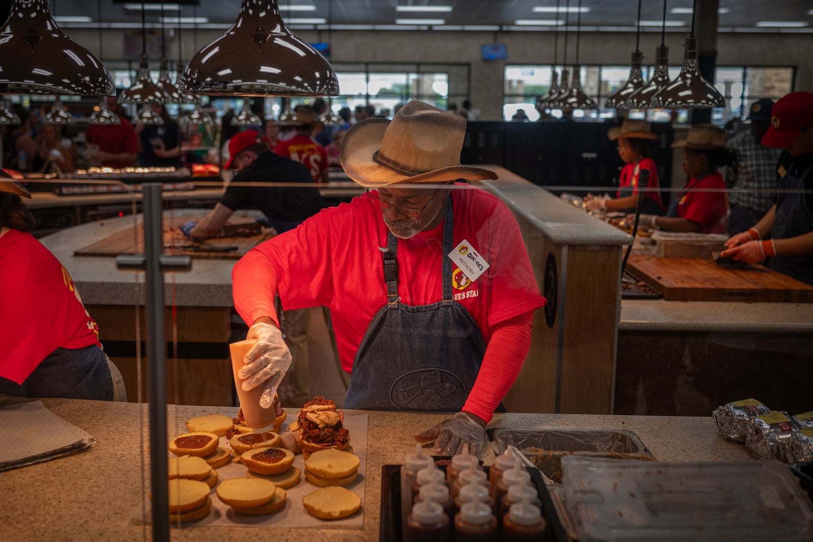 
                        Brisket and other barbecue sandwiches being made during the grand opening of a Buc-ee’s in Pass Christian, Miss., on June 9, 2025. The opening of the first location in Mississippi drew the usual cultish enthusiasm for the chain of mega convenience stores. (Emily Kask/The New York Times)
                      