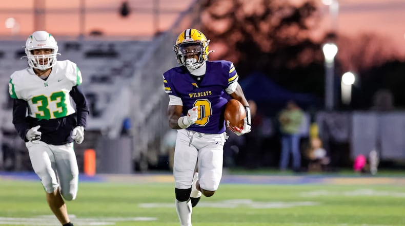 Springfield High School senior Deontre Long runs past Northmont senior Wyatt Smith during their game on Friday, Oct. 24 at Wildcat Stadium. The Wildcats won 56-7. MICHAEL COOPER / STAFF