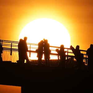 People watch the sunrise on New Year's Day in Seoul, South Korea, Thursday, Jan. 1, 2026. (AP Photo/Lee Jin-man)