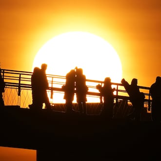 People watch the sunrise on New Year's Day in Seoul, South Korea, Thursday, Jan. 1, 2026. (AP Photo/Lee Jin-man)
