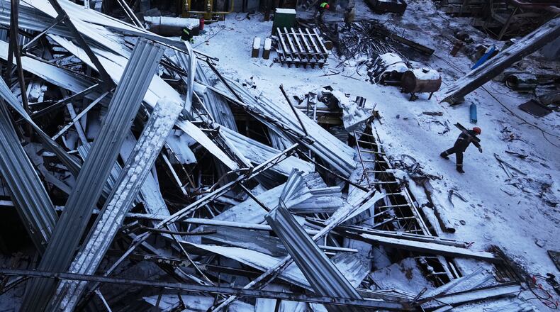 Workers repair the destroyed DTEK company's power plant after a Russian missile attack on the country's energy system in an undisclosed location in Ukraine, Monday, Feb. 9, 2026. (AP Photo/Sergei Grits)
