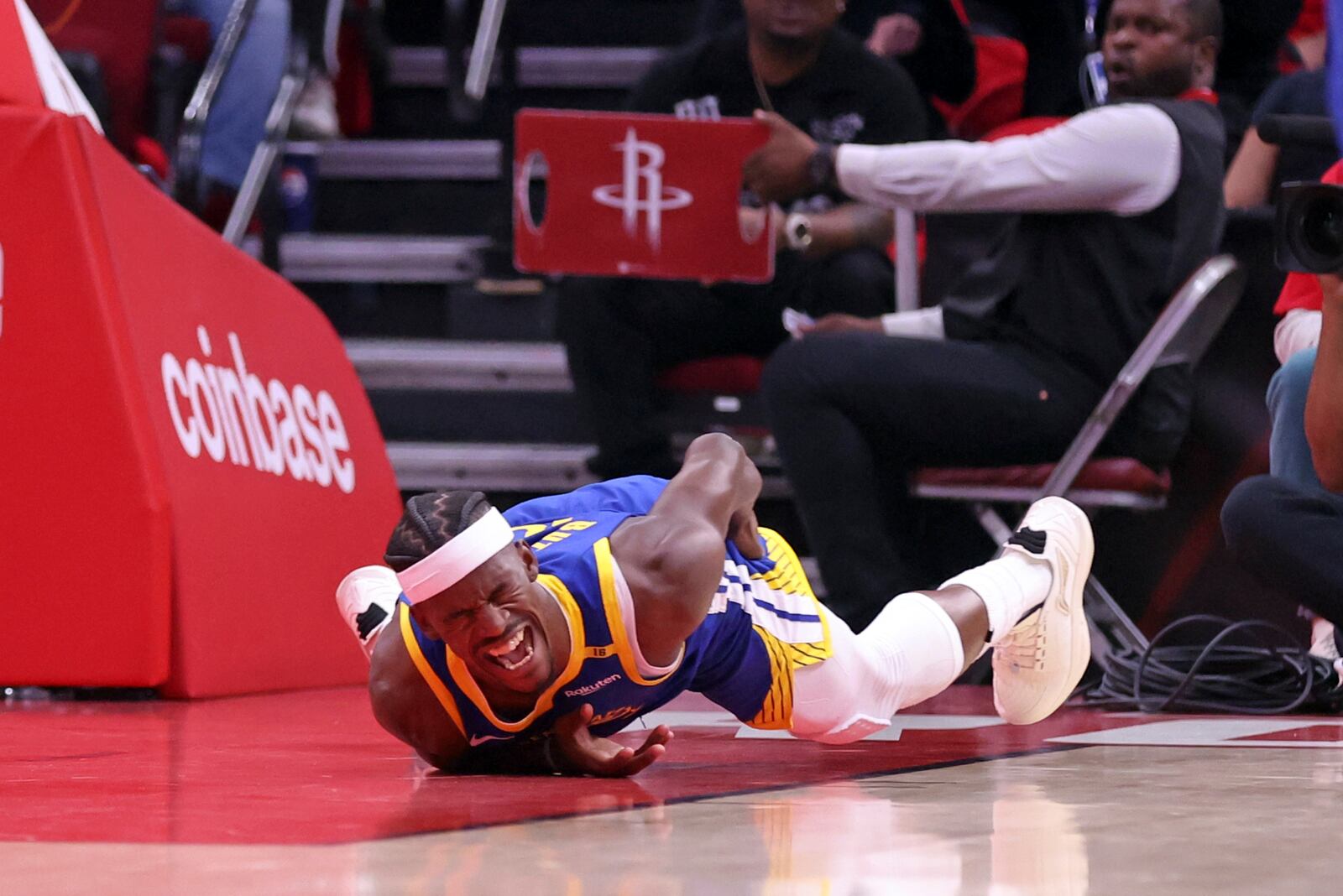 Golden State Warriors' Jimmy Butler III writhes in pain after injuring himself in 1st quarter against Houston Rockets in Game 2 of First Round of NBA Playoffs at Toyota Center in Houston, Texas on Wednesday, April 23, 2025. (Scott Strazzante/San Francisco Chronicle via AP)