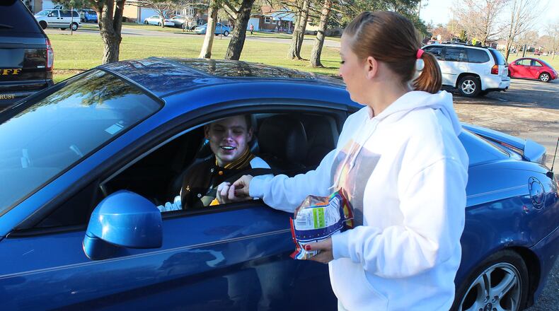The Clark County Combined Health District is collaborating with Auto Club AAA to conduct a countywide seat belt challenge between schools from April 11 to 14 and April 17 to 21. Here, Aryn Waag handed out candy to Kenton Ridge High School students who were wearing their seat belts a few years ago as they conducted safety checks FILE/STAFF