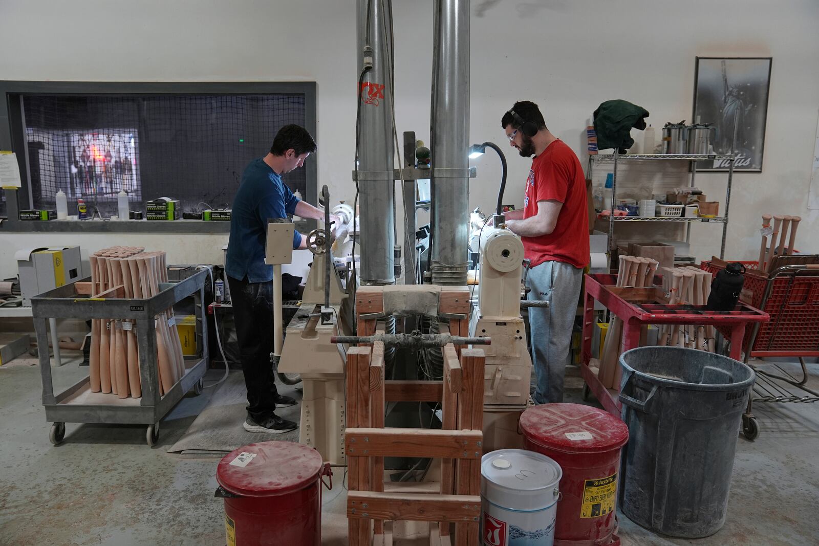 Jim Levasseur, left, and Joseph D'Emilio manufacture torpedo baseball bats at Victus Sports in King of Prussia, Pa., Wednesday, April 2, 2025. (AP Photo/Matt Rourke)