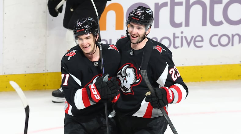 Buffalo Sabres center Ryan McLeod, left, celebrates his empty net goal with defenseman Mattias Samuelsson (23) during the third period of an NHL hockey game against the Philadelphia Flyers, Thursday, Dec. 18, 2025, in Buffalo, N.Y. (AP Photo/Jeffrey T. Barnes)