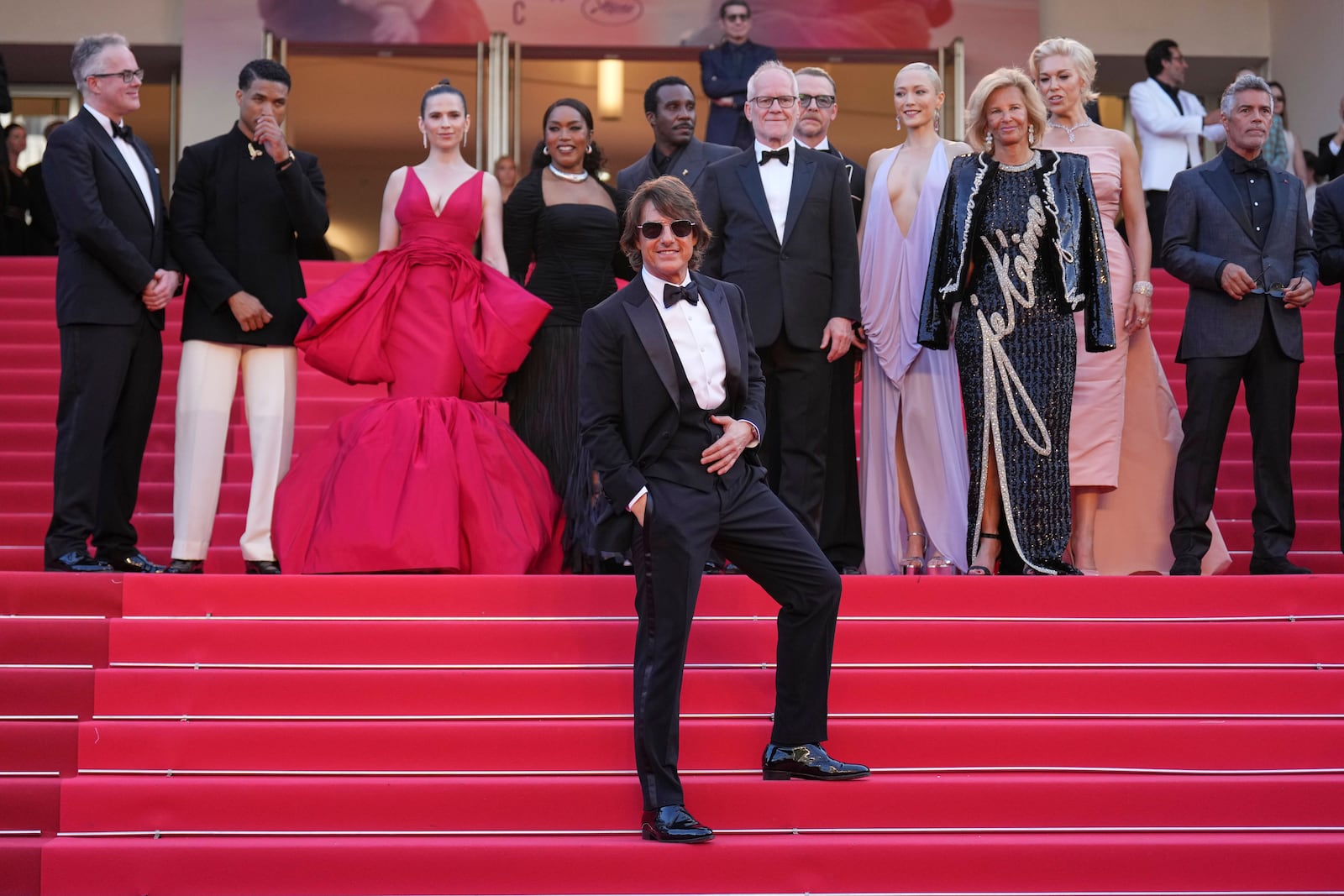 Tom Cruise, front, editor Eddie Hamilton, from back left, Greg Tarzan Davis, Hayley Atwell, Angela Bassett, Tramell Tillman, festival director Thierry Fremaux, Simon Pegg, Pom Klementieff, Iris Knobloch, Hannah Waddingham and Esai Morales pose for photographers upon arrival at the premiere of the film 'Mission: Impossible - The Final Reckoning' at the 78th international film festival, Cannes, southern France, Wednesday, May 14, 2025. (AP Photo/Natacha Pisarenko)