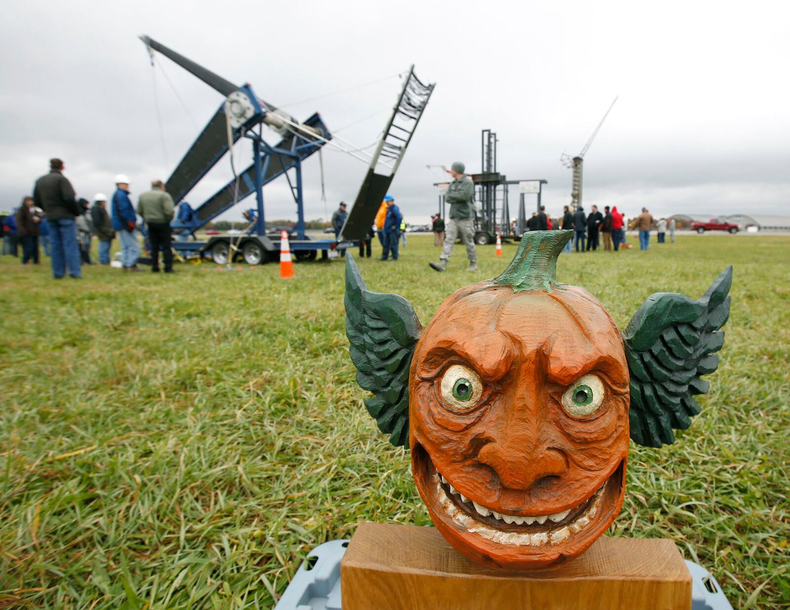 A trophy on display with Class A pumpkin chucking machines at Wright-Patterson Air Force Base on Friday afternoon.  The 14th annual Pumpkin Chuck was sponsored by the Air Force Life Cycle Management Center Engineering Directorate's STEM outreach.  More than 40 participants worked a dozen chucking machines to launch pumpkins from two pounds to 10 pounds as far as 3,800 feet.   TY GREENLEES / STAFF