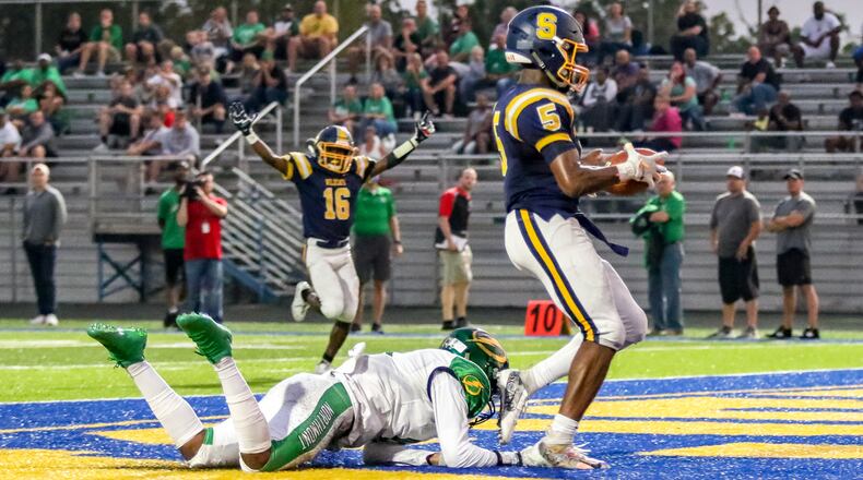 Springfield High School senior wide receiver Larry Stephens catches a touchdown pass during a game against Northmont on Friday night in Springfield. The Wildcats won 28-17. CONTRIBUTED PHOTO BY MICHAEL COOPER