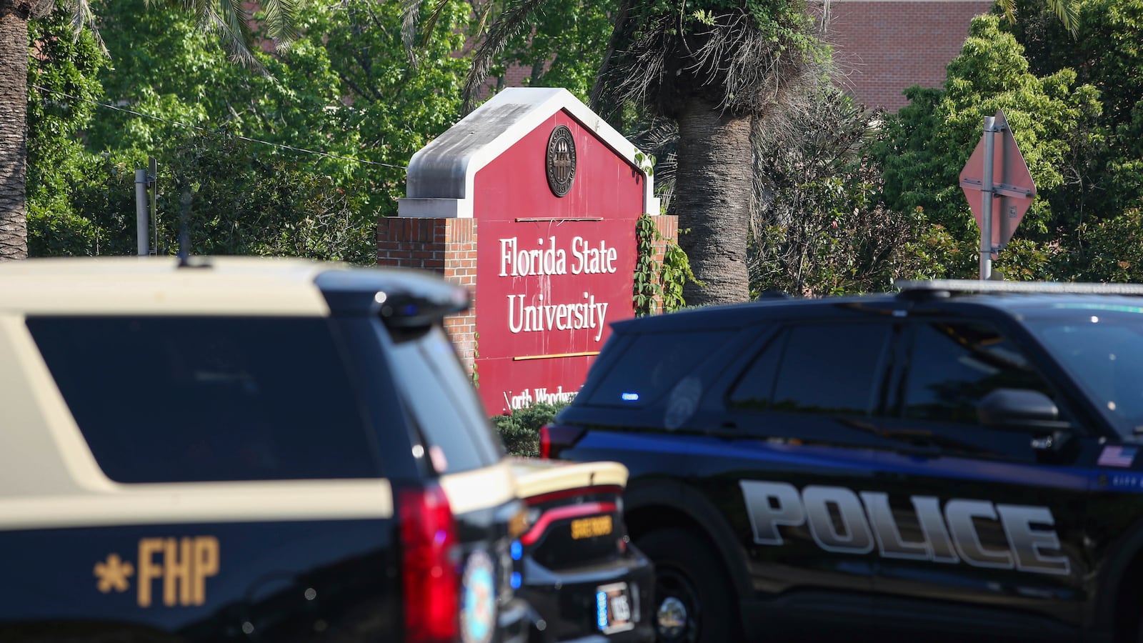 The Florida State Student Union building is seen behind law enforcement vehicles in Tallahassee, Fla., Thursday, April 17, 2025. (AP Photo/Gary McCullough)