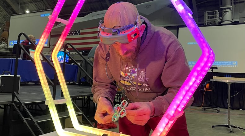 Kele Stanley, micro-drone race organizer, examines his drone, which weighs just 20 grams, before taking a practice run ahead of last year's race event at the National Museum of the U.S. Air Force.