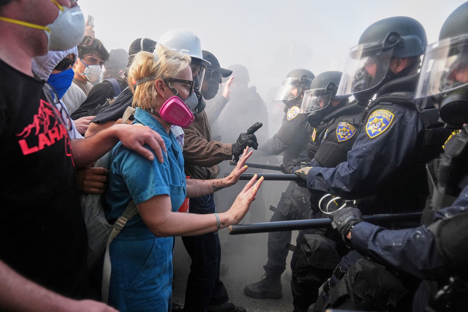 FILE - Protesters confront police on the 101 Freeway near the Metropolitan Detention Center in downtown Los Angeles, Sunday, June 8, 2025, following last night's immigration raid protest. (AP Photo/Jae C. Hong, File)