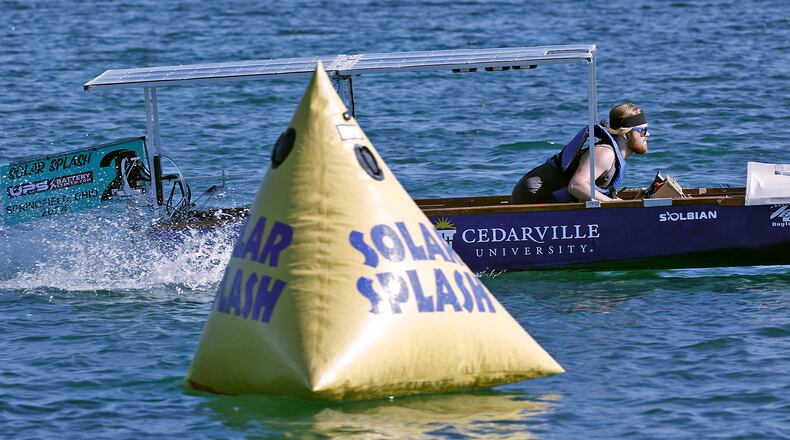 Kaden Torgerud, a student at Cedarville University, pilots his school's solar boat during one of the sprint heats at Solar Splash 2024 Friday. Teams from eight colleges, from as far away as the University of Puerto Rico, participated in this years event at Champions Park Lake. Solar Splash, in its 30th year, is the World Championship of Collegiate Solar Boat racing. The five day event starts on June 4 and features five on-the-water competitive events, the solar slalom, the solar endurance and the solar sprint. BILL LACKEY/STAFF