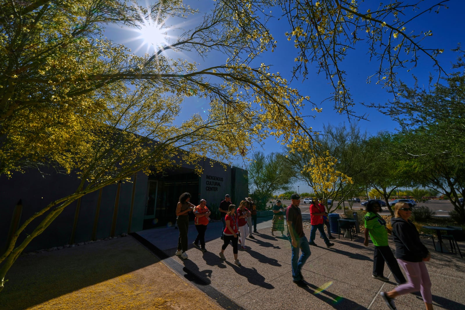 People walk in memory of loved ones during an observance of Missing & Murdered Indigenous Peoples Day (MMIP) at the Indigenous Cultural Center at Scottsdale Community College, Friday, May 2, 2025, in Scottsdale, Ariz. (AP Photo/Matt York)