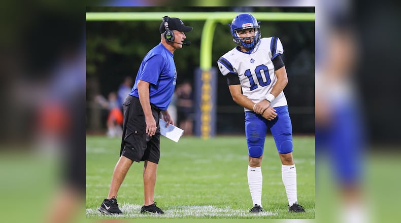 Brookville High School head coach Mike Hetrick gives a play call to junior Jayden Resor during their Southwestern Buckeye League game against Oakwood on Friday, Oct. 3, 2025 at Mack Hummon Stadium. BRYANT BILLING / STAFF