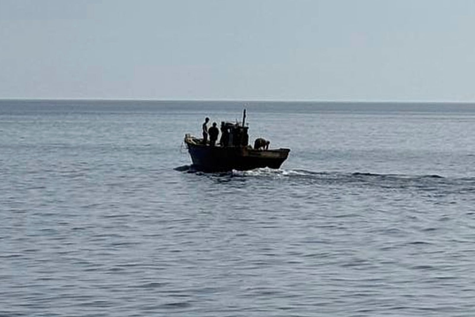 In this photo provided by South Korea Unification Ministry, a wooden boat carrying North Korean individuals move northward in the East Sea, South Korea, as South Korea sent the North Koreans back across their sea border, Wednesday, July 9, 2025. (South Korea Unification Ministry via AP)
