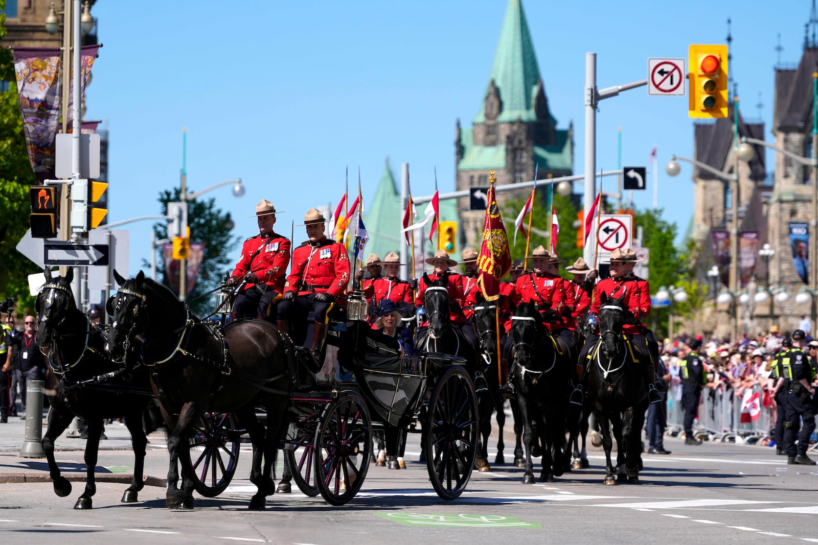 King Charles and Queen Camilla arrive by horse-drawn landau at the Senate of Canada building in Ottawa, Canada, during a royal visit on Tuesday, May 27, 2025. (Justin Tang/The Canadian Press via AP)