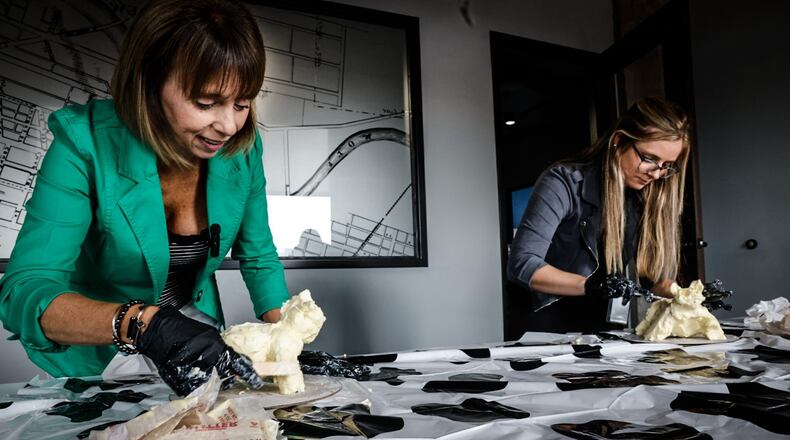 Food & Dining Reporter Natalie Jones (right) and Publisher Suzanne Klopfenstein (left) attempted to make their own butter cow in honor of the display at the Ohio State Fair. JIM NOELKER/STAFF