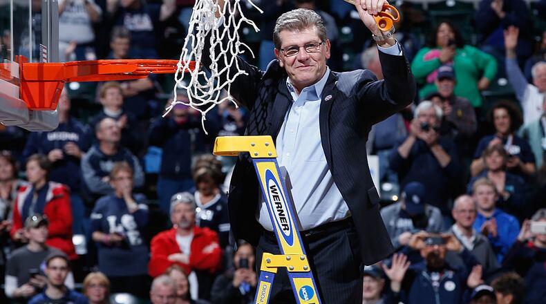 INDIANAPOLIS, IN - APRIL 05: Head coach Geno Auriemma of the Connecticut Huskies holds up the net after cutting it down following their 82-51 victory over the Syracuse Orange to win the 2016 NCAA Women’s Final Four Basketball Championship at Bankers Life Fieldhouse on April 5, 2016 in Indianapolis, Indiana. (Photo by Joe Robbins/Getty Images)