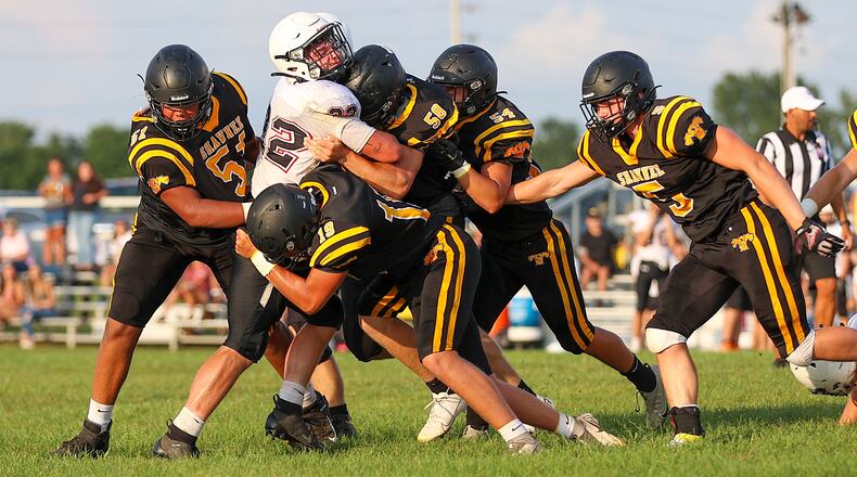 A group of Shawnee High School defenders tackle Greenon's Trevor Stewart during their scrimmage game on Friday, Aug. 13 in Springfield. CONTRIBUTED PHOTO BY MICHAEL COOPER