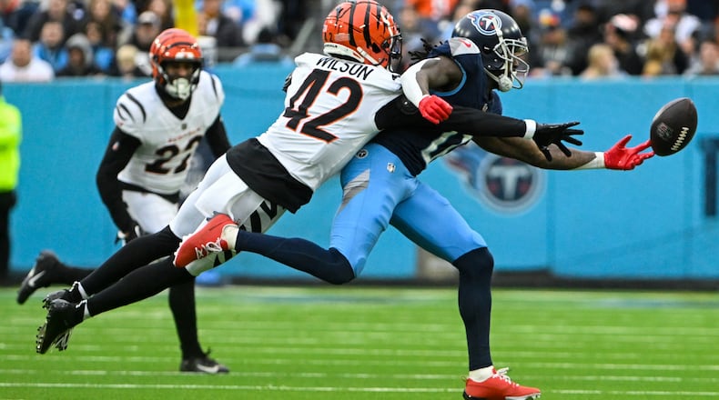 Tennessee Titans wide receiver Calvin Ridley (0) is unable to hold on to a catch as Cincinnati Bengals cornerback Marco Wilson (42) defends during the second half of an NFL football game Sunday, Dec. 15, 2024, in Nashville, Tenn. (AP Photo/John Amis)