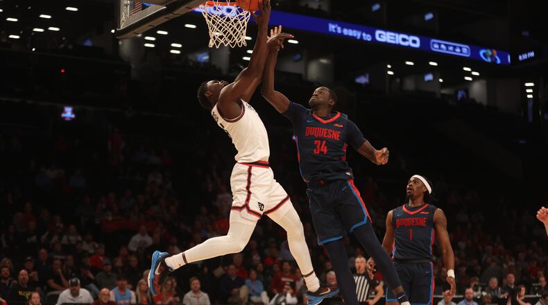 Dayton's Enoch Cheeks shoots against Duquesne in the Atlantic 10 Conference tournament quarterfinals on Thursday, March 14, 2024, at the Barclays Center in Brooklyn, N.Y. David Jablonski/Staff