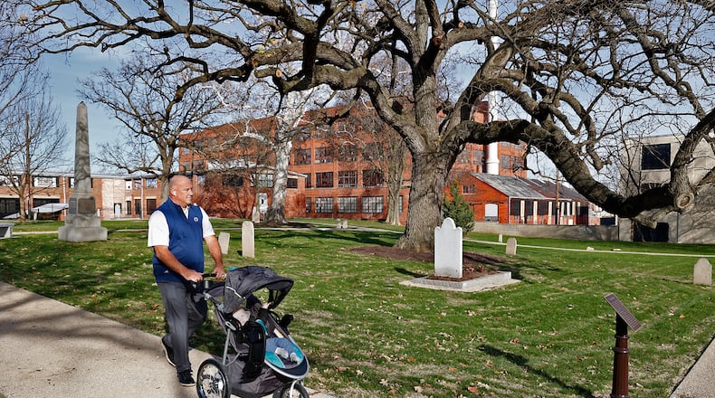 Dan Kelly pushes his grandson, Jack, as they explore the renovated Springfield Burying Ground, the oldest cemetery in the city, Thursday, Nov. 10, 2022. BILL LACKEY/STAFF