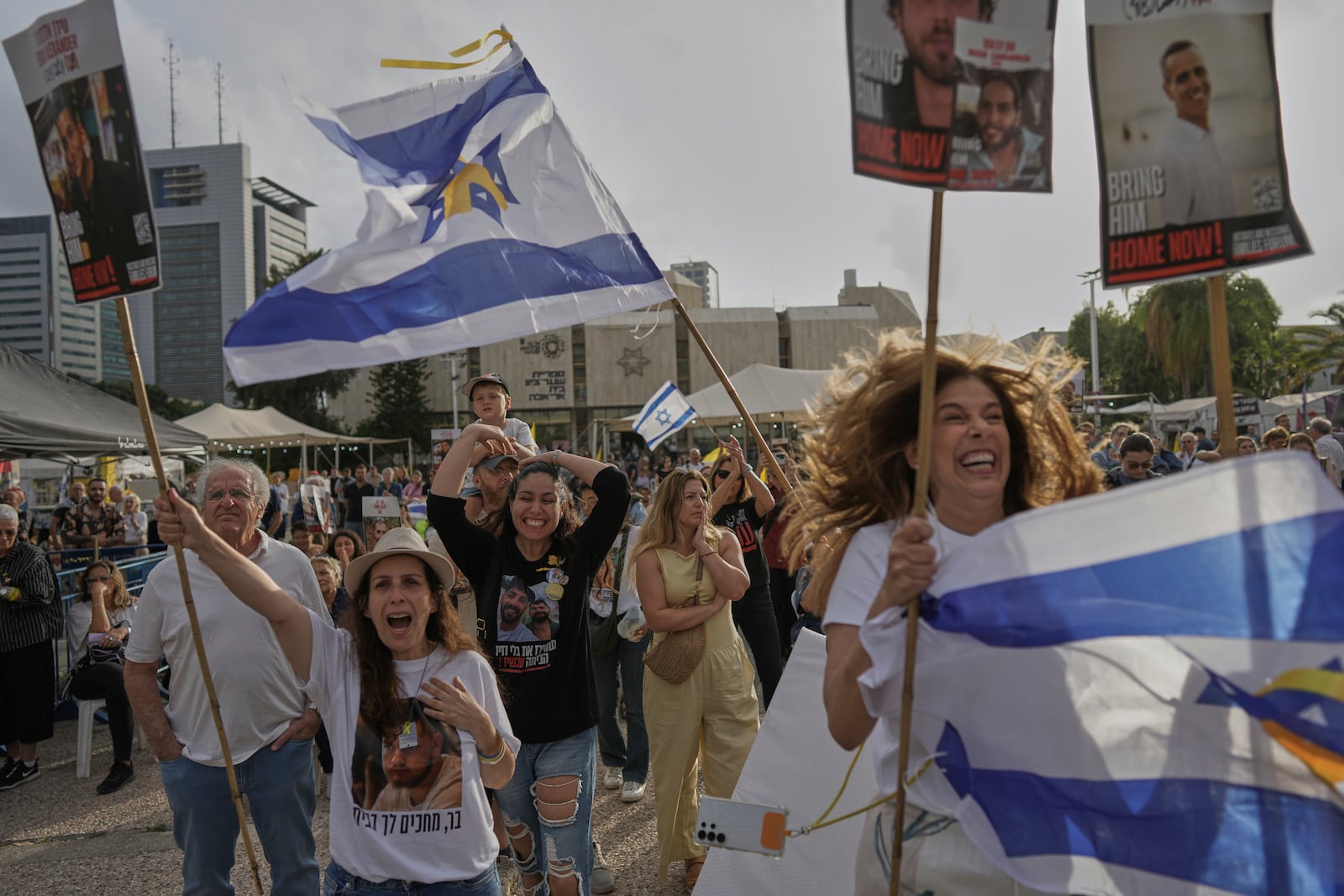 People react as they gather to watch a live broadcast of Israeli-American soldier Edan Alexander to be released from Hamas captivity in Gaza, at a plaza known as the hostages square in Tel Aviv, Monday, May 12, 2025. Alexander was abducted during the Hamas-led attack on his base on October 7, 2023. (AP Photo/Oded Balilty)