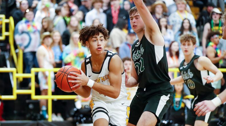 Shawnee High School junior Desmond Houseman drives past Catholic Central's Ian Roediger during their game on Dec. 20, 2022 in Springfield. CONTRIBUTED PHOTO BY MICHAEL COOPER