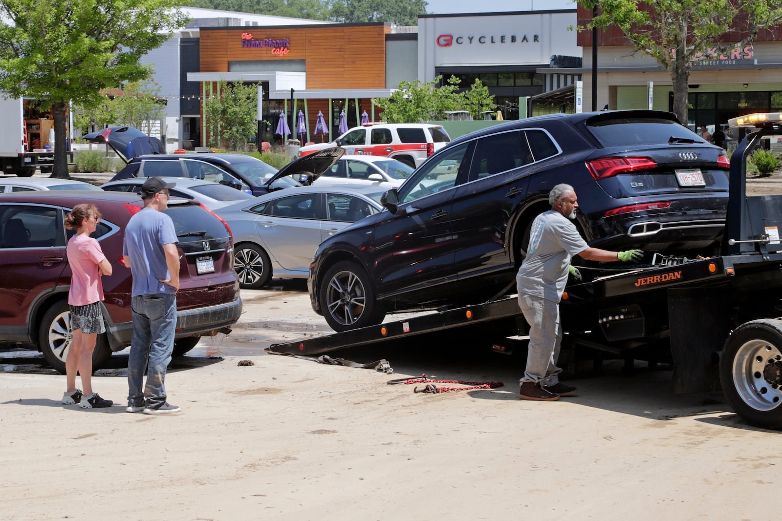 Dozens of cars were towed from a parking lot at University Place shopping center after they were flooded out during tropical storm Chantal, Monday, July 7, 2025, in Chapel Hill, N.C. (AP Photo/Chris Seward)