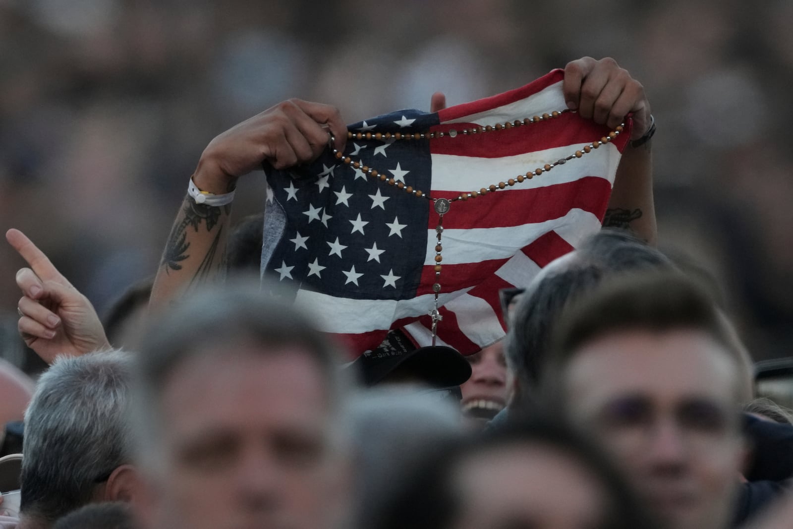 An American flag is waved following the election of Pope Leo XIV, at the Vatican, Thursday, May 8, 2025. (AP Photo/Andrew Medichini)