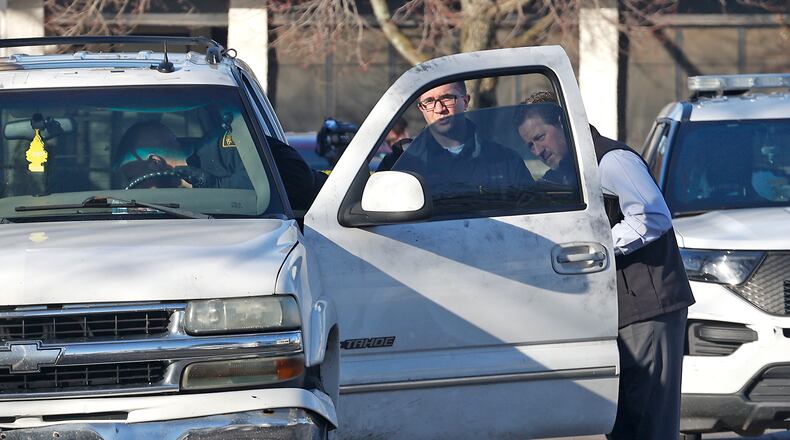 The Springfield Police Division investigate Chevy Tahoe, parked along Mason Street, where a man was found with a gunshot wound to the head Tuesday, Feb. 6, 2024. BILL LACKEY/STAFF