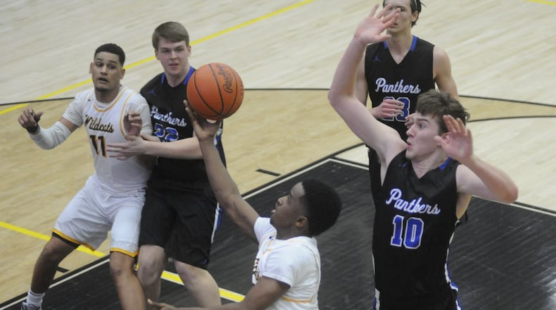Michael Wallace (with ball) of Springfield avoids Garett Powell of Springboro. Springfield won the D-I sectional semi 77-60 at Centerville on Tuesday, Feb. 27, 20118. MARC PENDLETON / STAFF