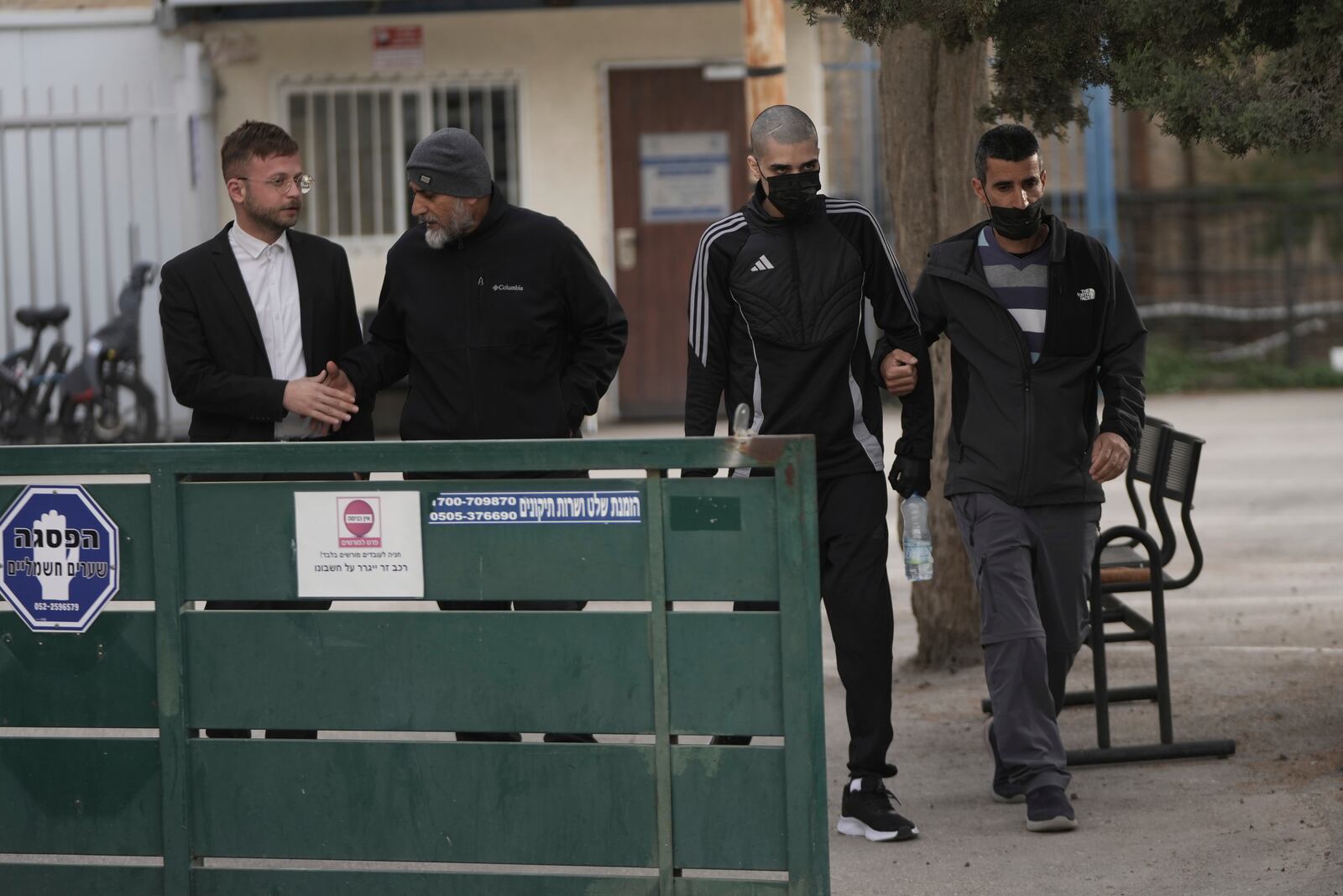 Palestinian Ahmed Manasra , second right, who took part in an attack in 2015 when he was 13 and developed schizophrenia in prison, walks during his release in Jerusalem, Thursday, April 10, 2025. (AP Photo/Mahmoud Illean)