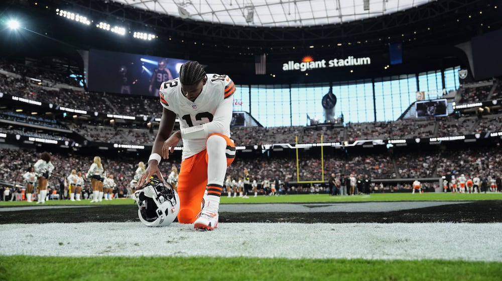 Cleveland Browns quarterback Shedeur Sanders (12) kneels in the end zone before an NFL football game against the Las Vegas Raiders, Sunday, Nov. 23, 2025, in Las Vegas. (AP Photo/Candice Ward)