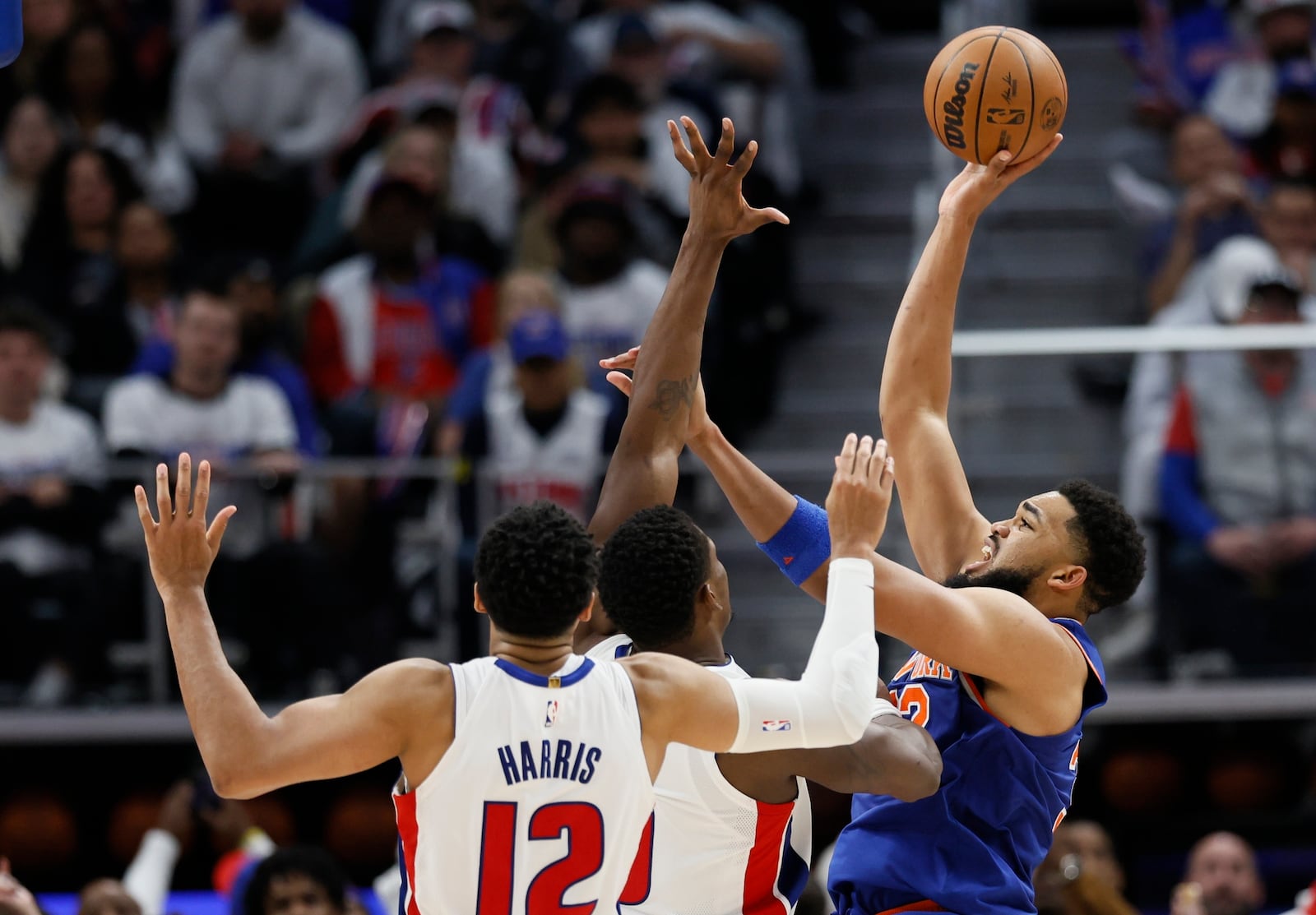 New York Knicks center Karl-Anthony Towns, right, looks to shoot against Detroit Pistons forward Tobias Harris (12) and center Jalen Duren, center, during the second half of Game 6 of an NBA basketball first-round playoff series Thursday, May 1, 2025, in Detroit. (AP Photo/Duane Burleson)