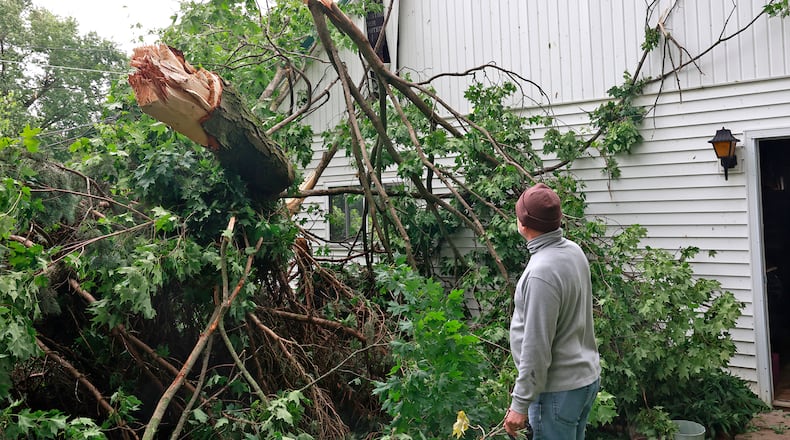 Tony Mitchell, a Christiansburg resident, surveys the damage to his garage Monday, June 12, 2023. A storm Sunday night toppeled trees and knocked out power in the Champaign County town. BILL LACKEY/STAFF